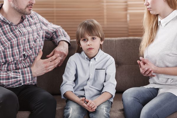 Close-up,Of,Sad,Child,And,His,Parents,Arguing.,Problem,In